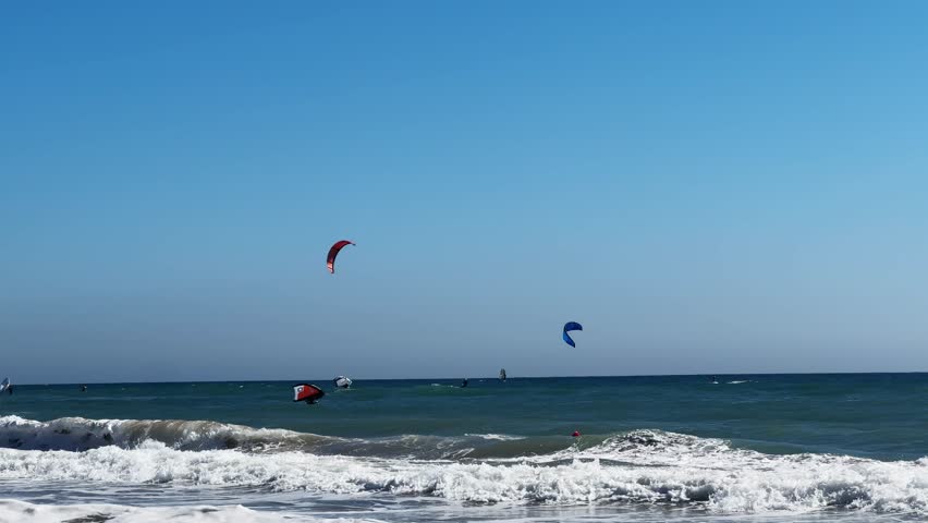 Kite surfing. Silhouettes of a kite boarders making trick. Watersport activity. 