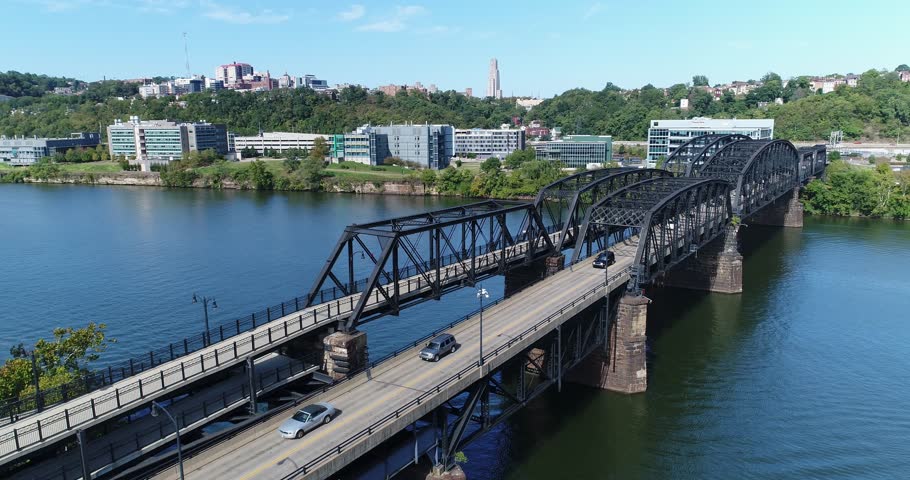 A slow reverse aerial view of the Hot Metal Bridge over the Monongahela River on Pittsburgh