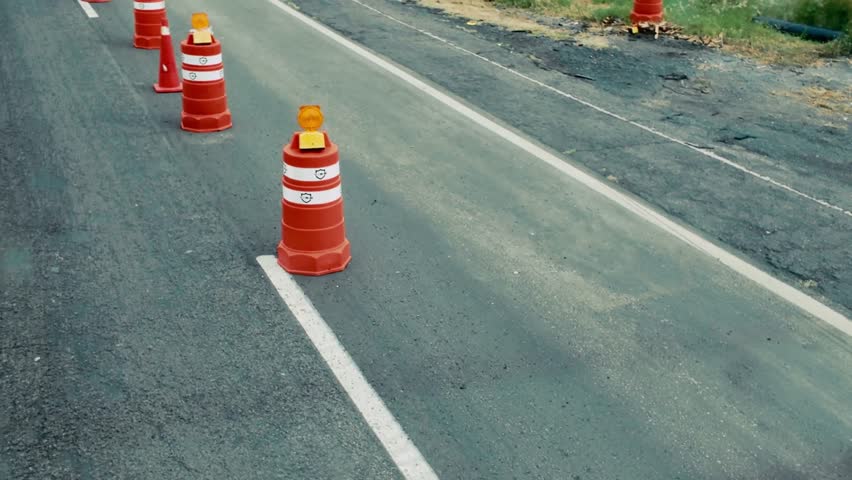 Road construction with safety cones marking work zone on highway - Powered by Shutterstock - Get 15% off with code: PIKWIZARD15