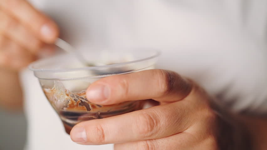 Close up of a beautiful woman woman eating chocolate pudding.. High quality FullHD footage