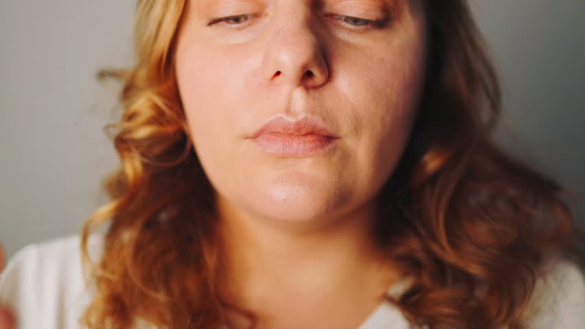 Close up of a beautiful woman woman eating chocolate pudding.. High quality FullHD footage