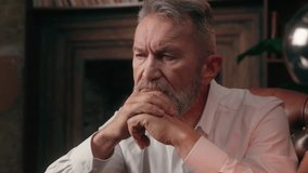 Old Caucasian man looking framed photograph picture photo memories past remember thinking male pensioner elderly senior grandfather health medicine considering indoor businessman mature home glasses - Powered by Shutterstock - Get 15% off with code: PIKWIZARD15