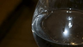 A relaxing and satisfying pattern emerges from the water as a woman runs her finger around the rim of a wine glass. - Powered by Shutterstock - Get 15% off with code: PIKWIZARD15