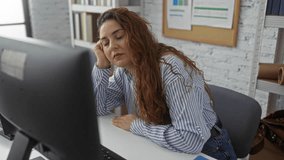 Woman sleeping at desk in modern office feeling tired and exhausted suggests a busy workday in a professional setting with natural light and organized workspace. - Powered by Shutterstock - Get 15% off with code: PIKWIZARD15
