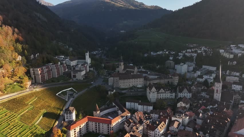 Aerial view of Chur, Graubünden, Switzerland, showcasing the charming townscape, historic architecture, and scenic vineyards nestled within a mountainous landscape.