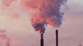 Two Industrial Factory Chimneys Producing Large Amount of Smoke and Pollution at Sunset, Emission and Global Warming with Beautiful Colors and Sky - Powered by Shutterstock - Get 15% off with code: PIKWIZARD15