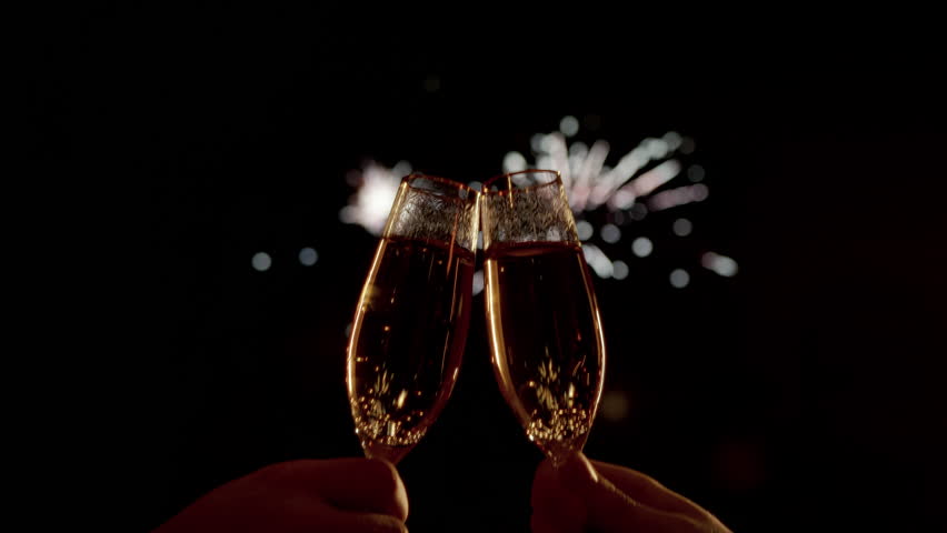 Two Champagne Glasses Clinking and Toasting Under a Dark Sky Lit by Fireworks on New Year's Eve, Festive and Celebratory Mood, party cheers with sparkling bubbles and golden reflections