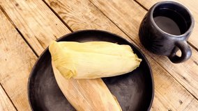 Tamales and coffee on rustic table, conveying warmth and tradition - Powered by Shutterstock - Get 15% off with code: PIKWIZARD15
