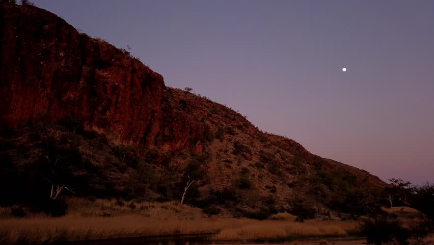 TIME LAPSE: Glen Helen Gorge at sunrise with waterhole on Finke River. Tjoritja West MacDonnell Ranges in Northern Territory, Australia. Australian outback along Red Centre Way, west of Alice Springs