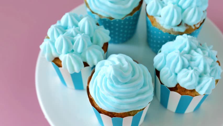 Cupcakes with blue cream .Top view. Rotate. delicious portioned cakes.Cream cakes assortment. Sweet pastries and desserts. 4k footage