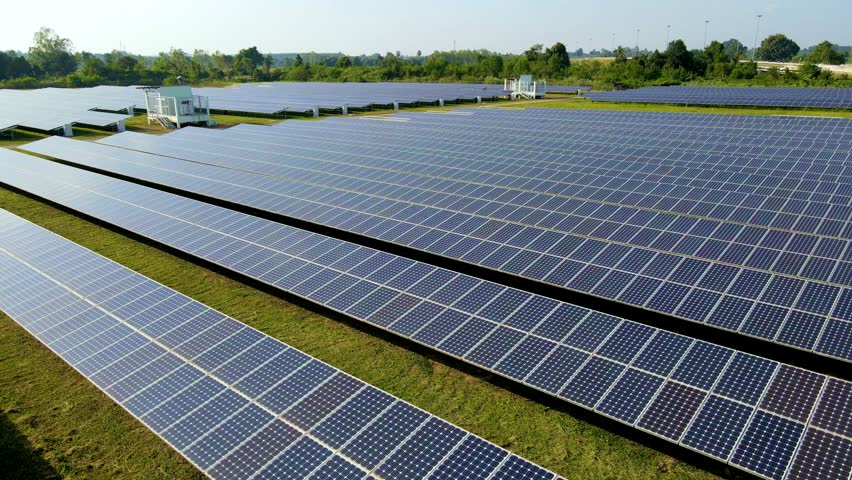 Explore a vast solar park in Thailand where rows of solar panels harness sunlight, contributing to sustainable energy.