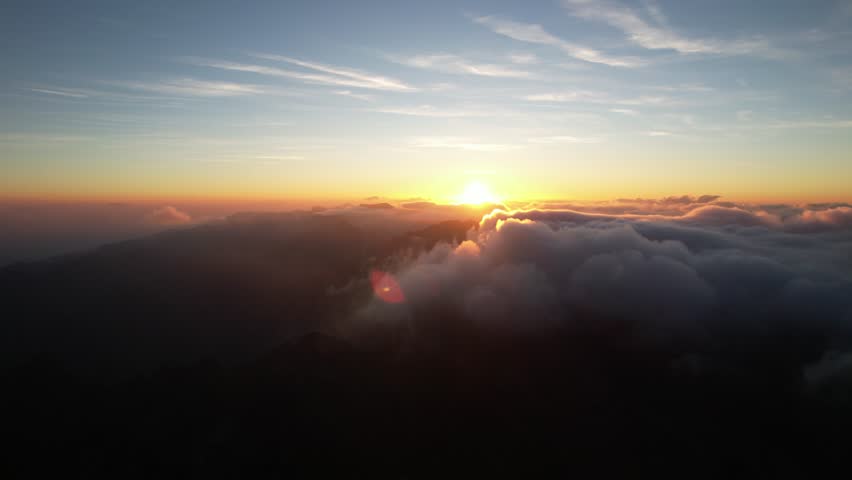 A breathtaking sunrise above fluffy clouds from a high viewpoint, serene and majestic