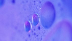 Vertical video. Sparkling serum. Foam swirl. Defocused neon purple blue color oil emulsion texture paint water mix motion abstract art background. - Powered by Shutterstock - Get 15% off with code: PIKWIZARD15