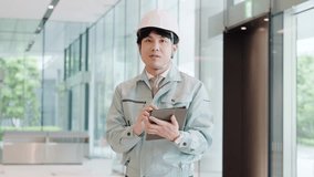 A man wearing work clothes working with a smile - Powered by Shutterstock - Get 15% off with code: PIKWIZARD15