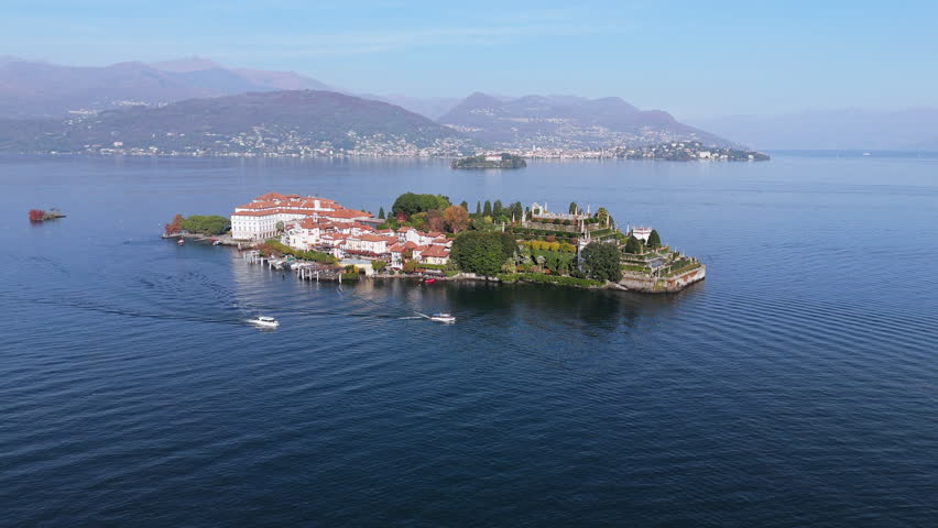 Serene aerial view of Isola Bella on Lake Maggiore, Italy, with boats cruising