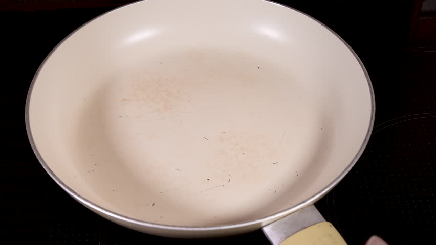 Worn non stick frying pan with scratched surface