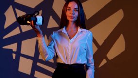 Woman explores digital realms with VR glasses amidst vibrant colors and dynamic patterns - Powered by Shutterstock - Get 15% off with code: PIKWIZARD15