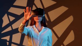 Woman explores digital worlds using VR glasses against a vibrant backdrop - Powered by Shutterstock - Get 15% off with code: PIKWIZARD15