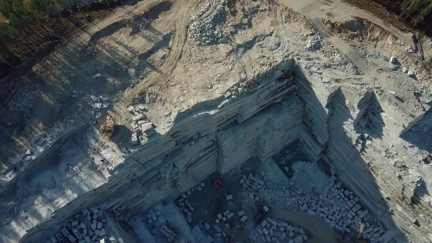 Part Of Granite quarry Viewed From Air. Stone Extraction For Building Materials Production. Blocks And Slabs At Production Site. Granite Production. Natural Resources Mining.