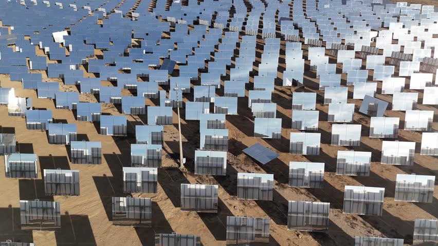 Aerial view of the Ashalim solar power station in Israel, featuring its iconic solar tower, reflective mirrors, and vast desert surroundings, showcasing renewable energy innovation and sustainability.