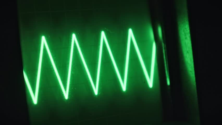 Vintage CRT oscilloscope screen shows dynamic green waveforms, ideal for tech-themed projects, backgrounds, or illustrating scientific processes.