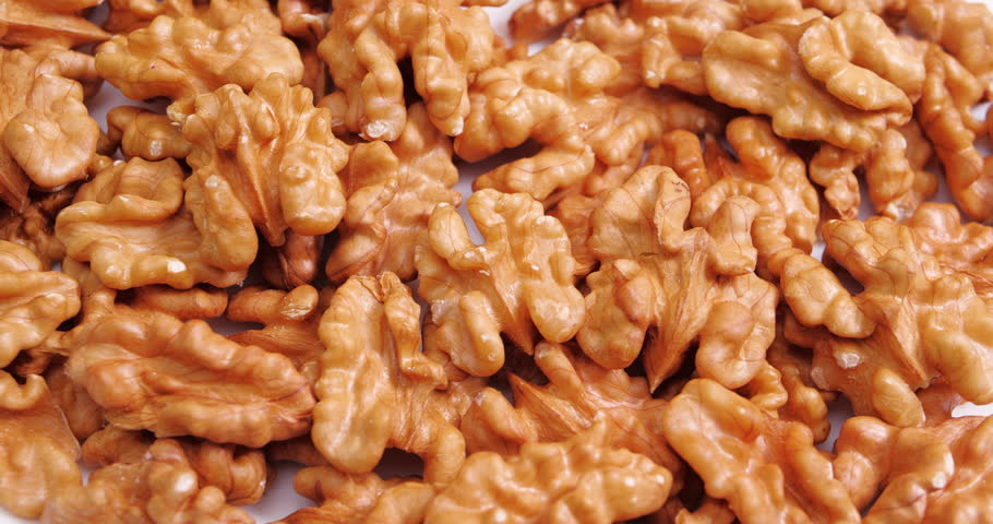 Walnut Halves Rotating on a White Background. Raw healthy ingredient Concept. Vegan Food