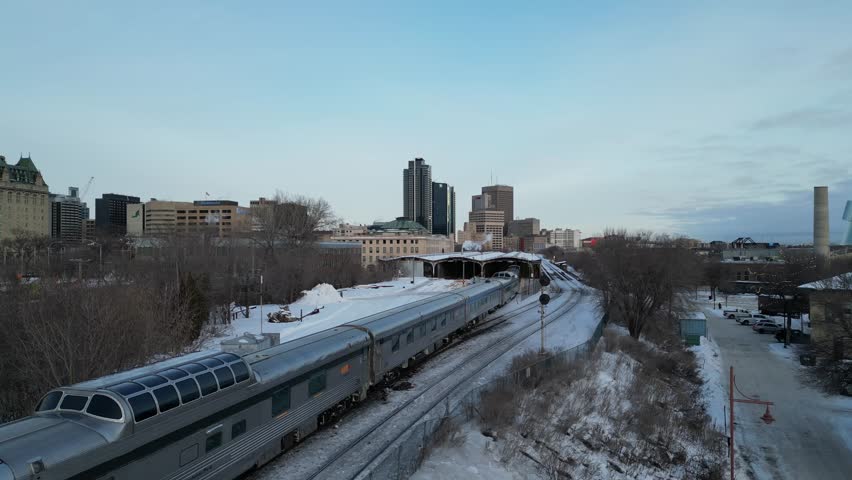 VIA Rail The Canadian arriving into Winnipeg Union Station on winter morning drone aerial