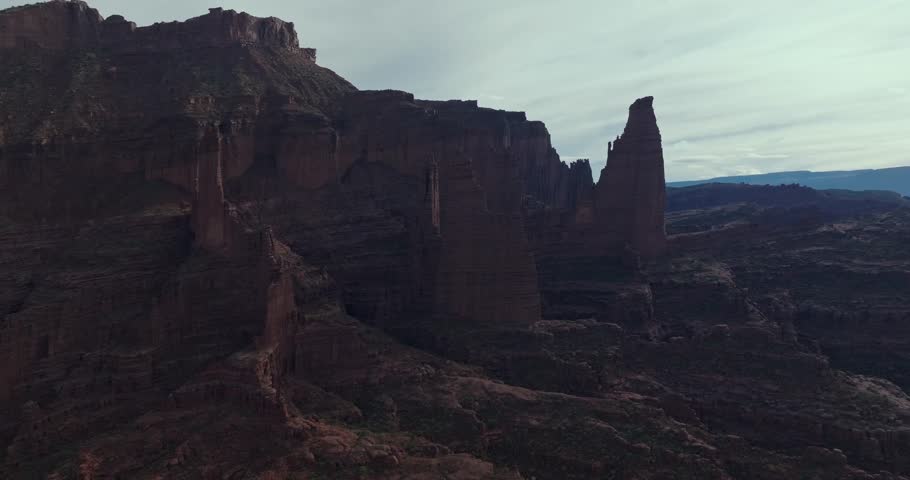 Fisher Towers in Moab with tall red rock formations, a serene desert atmosphere