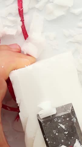 A colored candle is slowly cut with sandpaper. Close-up. Asmr. Soothing, relaxing asmr video .