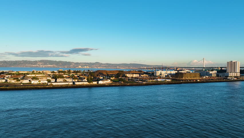 Aerial tracking shot of the shore of Treasure island, golden hour in San Francisco