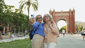 Senior tourists taking selfies in barcelona - Powered by Shutterstock - Get 15% off with code: PIKWIZARD15