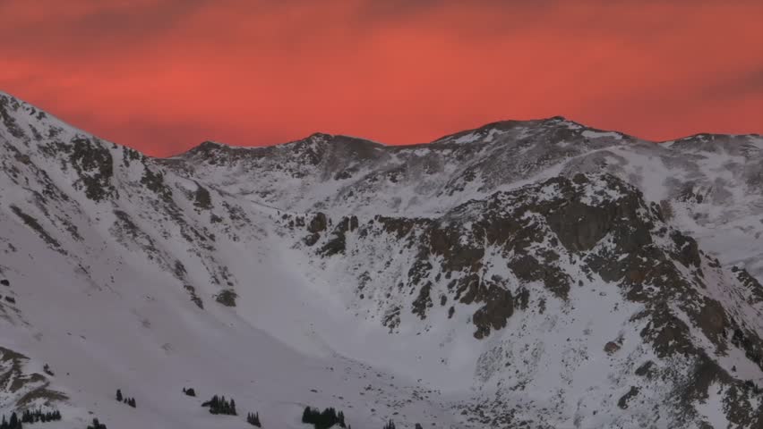 Last light winter solstice December snowy Rocky Mountains peaks golden hour aerial drone Colorado Continental Divide Loveland Pass Herman Gulch Coon Hill vibrant sunset dusk rugged parallax right