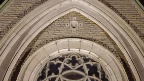 Close-up of a detailed Gothic rose window with intricate stone tracery and stained glass set in a historic stone church facade - Powered by Shutterstock - Get 15% off with code: PIKWIZARD15
