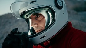 Astronaut With Helmet Looks Around And Opens Helmet Visor In New Planet - Powered by Shutterstock - Get 15% off with code: PIKWIZARD15