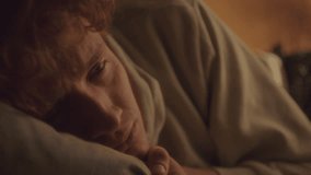 Emotional young man with red, tearful eyes resting on pillow and crying, experiencing depression and sadness. Close-up shot - Powered by Shutterstock - Get 15% off with code: PIKWIZARD15