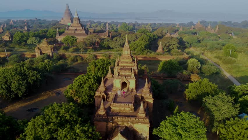 Witness the breathtaking beauty of Bagan Myanmar as golden sunlight bathes ancient temples and pagodas. The serene landscape reveals a rich history waiting to be discovered.
