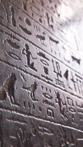Vertical egyptian hieroglyphs on the stone in The Museum in Cairo. Heritage of ancient civilization in archaeological excavation