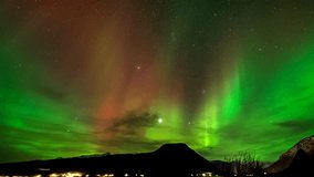 Mesmerizing aurora borealis flaring in starlit sky, time lapse over Balsfjord - Powered by Shutterstock - Get 15% off with code: PIKWIZARD15