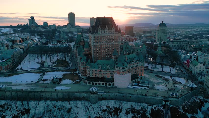 aerial shot around hotel Fairmont le Chateau Frontenac in Old Quebec City during winter at sunset, Quebec province, Canada