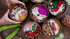 Fresh Bowls of Healthy Smoothie with Ripe Fruits and Juicy Berry on Beautiful Wood Table Close Up. Concept of Summer Meal of Raw Banana and Acai Mash. Top View on Strawberry Muesli and Coconut Flakes - Powered by Shutterstock - Get 15% off with code: PIKWIZARD15