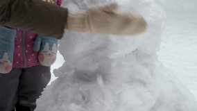 A loving mother and her young daughter build a snowman together in a winter wonderland. Their mitten-clad hands carefully shape snowballs, creating joyful memories in the frosty outdoors. - Powered by Shutterstock - Get 15% off with code: PIKWIZARD15