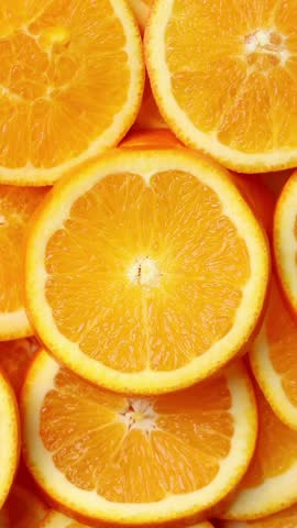 Heap of orange slice rotation. Top view shot