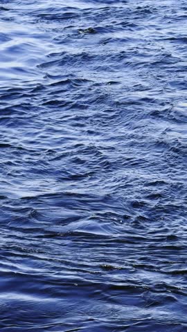Blue ocean water with rippling waves creates serene and natural background perfect for relaxation or nature concepts.