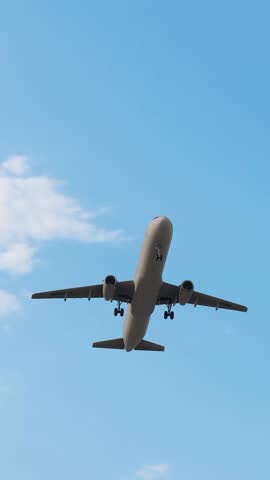 ULTRA HD. 4K. Airplane flies in blue sky. Travel, tourism. Airplane takes off against the background of blue sky.  