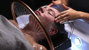 Spa treatment with Japanese head massage and hair washing in slow motion, young woman pampering, luxurious beauty treatment in a shampoo stand - Powered by Shutterstock - Get 15% off with code: PIKWIZARD15