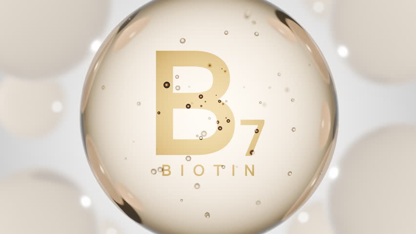 A golden glossy sphere with vitamin B7. Biotin pill capsule. Abstract 3D bubble drop background