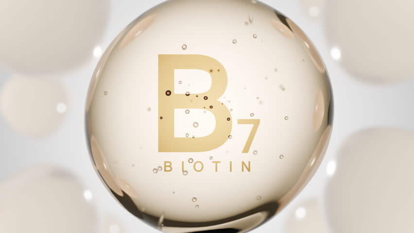 A golden glossy sphere with vitamin B7. Biotin pill capsule. Abstract 3D bubble drop background