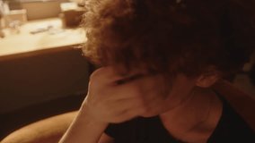 Despaired young man sitting in sunlit room, crying and wiping tears from his face in moment of sadness or depression. Close-up shot - Powered by Shutterstock - Get 15% off with code: PIKWIZARD15