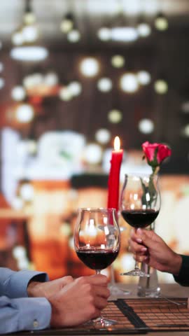 Portrait Of Romantic Couple Toasting Red Wine At Dinner