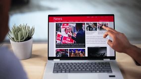 Watching Online News Article On Mobile Phone And Laptop. Electronic Newspaper - Powered by Shutterstock - Get 15% off with code: PIKWIZARD15